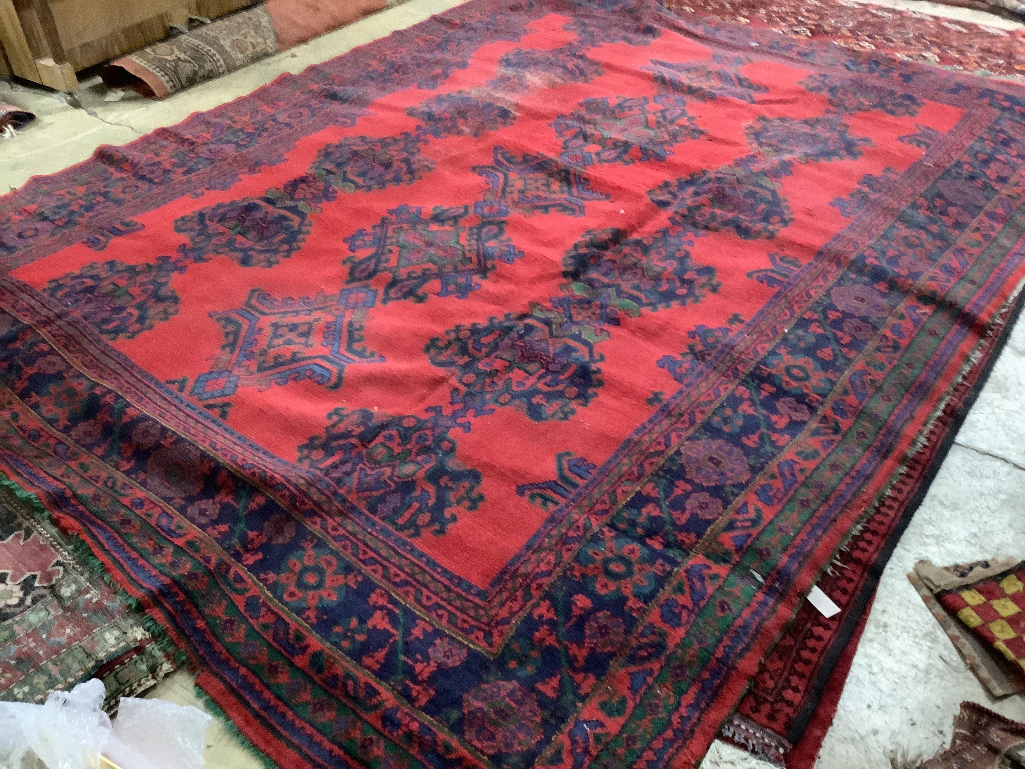 A Turkish red ground carpet, 350 x 278cm